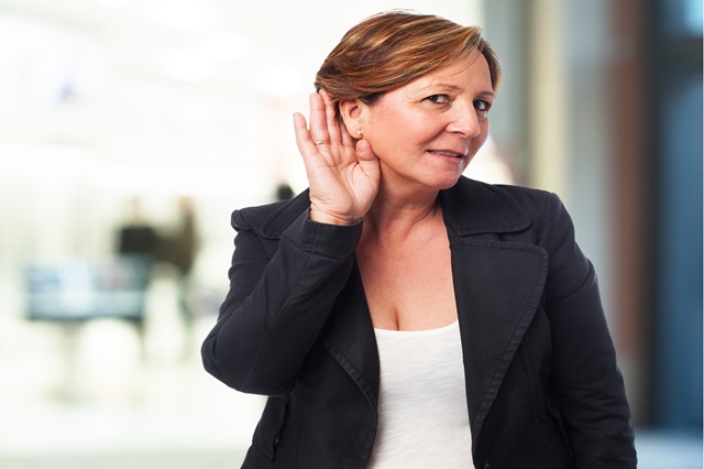 portrait of a mature business woman listening to something